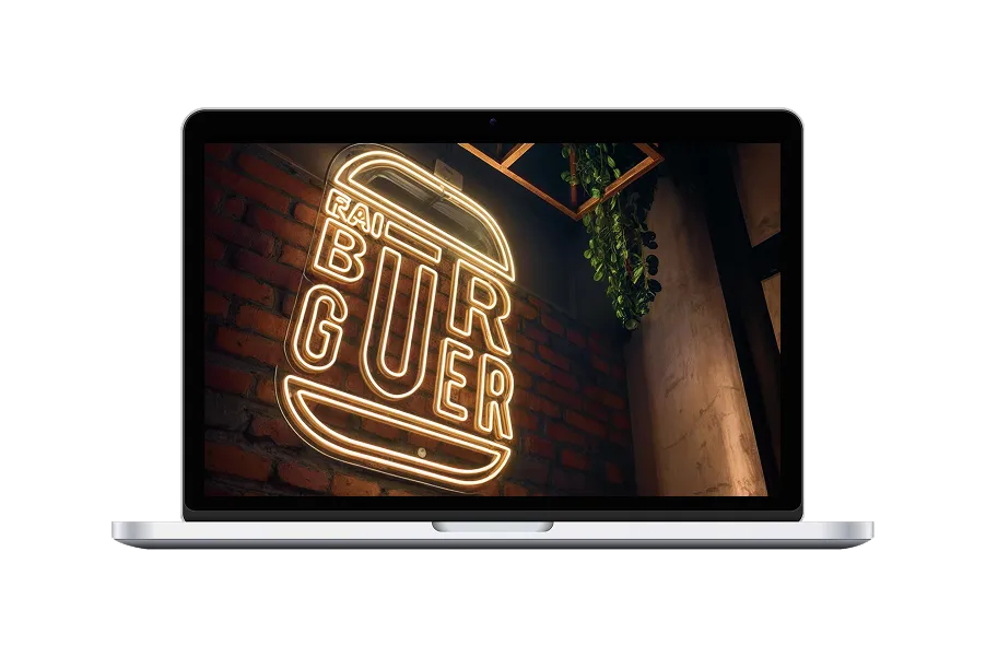 Diseño de letrero neón Burger proyectado en pantalla de laptop sobre pared de ladrillo